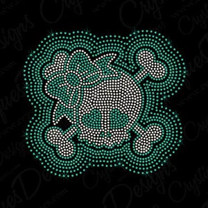 May include: A green and white skull and crossbones design made of rhinestones. The skull is outlined in green rhinestones and the crossbones are white rhinestones.