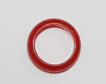 May include: A simple red ring made of smooth, polished stone.