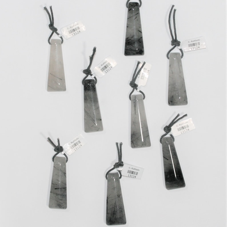 May include: Seven black and white crystal pendants with black cords. Each pendant has a label with the text "C. Rufilado 13124".