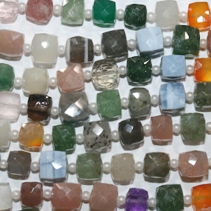May include: A close-up shot of a selection of gemstone beads in various colours, including pink, green, and brown. The square-shaped beads are strung together with small white pearls, creating a textured pattern. The gemstones have a faceted cut.