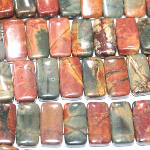 May include: A strand of rectangular, polished, red, brown, and green jasper beads. The beads have a mottled, marbled appearance.