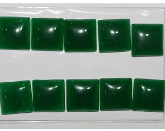 May include: Ten square-shaped green cabochons, arranged in two rows of five, on a white background.