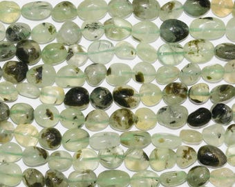 May include: A strand of green and black gemstone beads. The beads are smooth and oval-shaped. They are perfect for making jewelry.