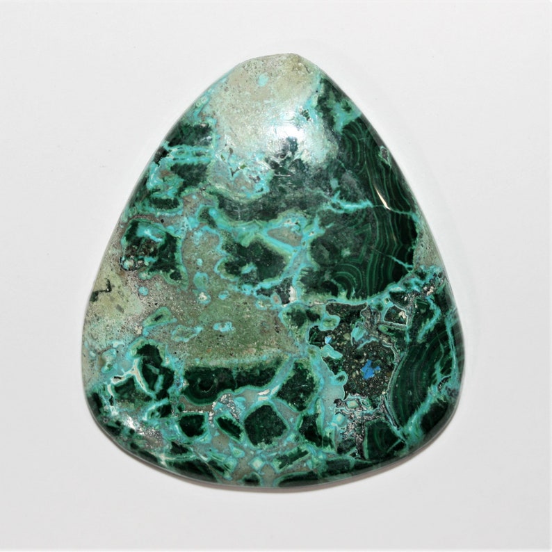 May include: A green and blue gemstone cabochon with a swirling pattern. The stone is cut in a teardrop shape and has a polished finish.