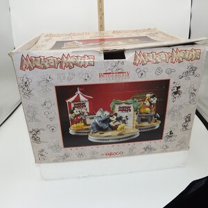 May include: A boxed set from the "Best of Mickey Collection" featuring three figurines with Mickey Mouse and friends. The box has the Mickey Mouse logo and sketches of Mickey. The set is from 1996 by Enesco.