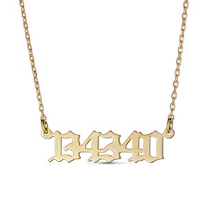 May include: Gold necklace with a pendant featuring the number 1490 in a gothic font.