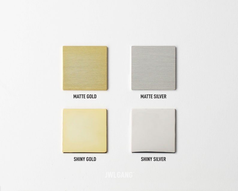 May include: Four metal squares, two gold and two silver, showing the different finishes available: matte gold, shiny gold, matte silver, and shiny silver.