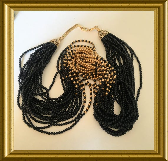 Necklace with black and 14‑carat gold beads