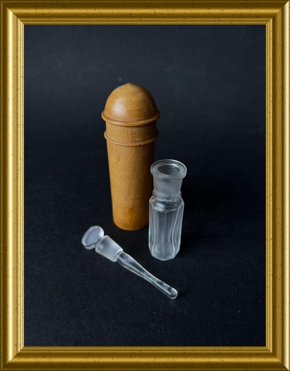 Antique small glass perfume bottle in a wooden case