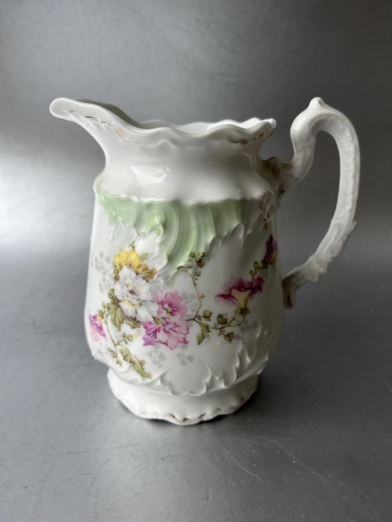 Antique porcelain jug with floral decoration