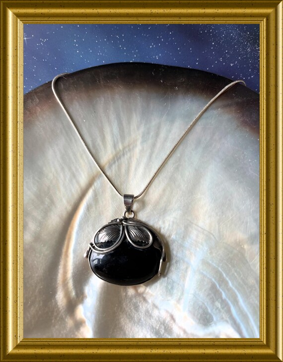 Silver pendant with black stone on necklace