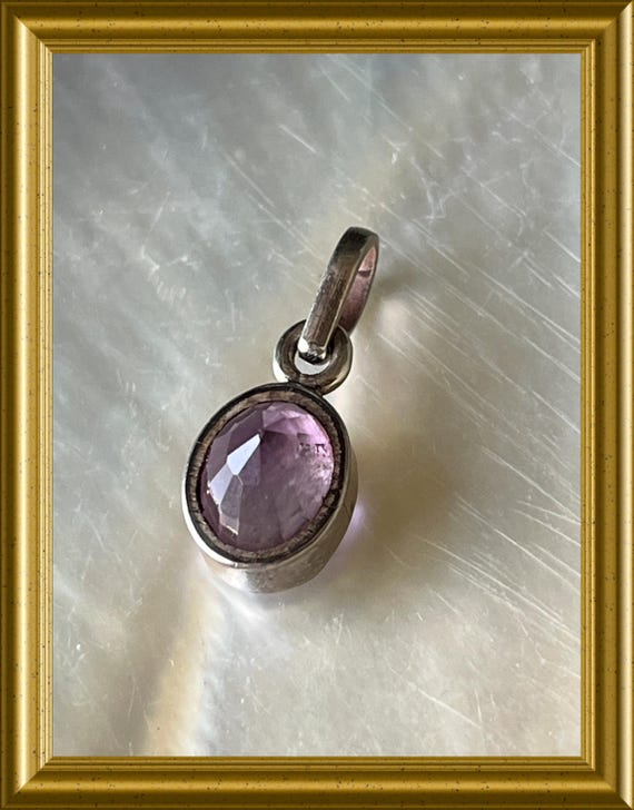 Small silver pendant with faceted amethyst