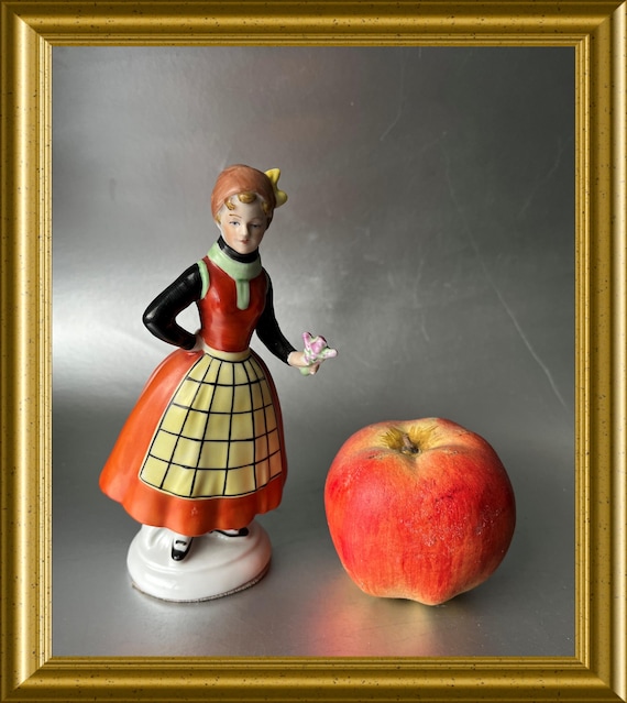 Antique porcelain figurine: woman with apron
