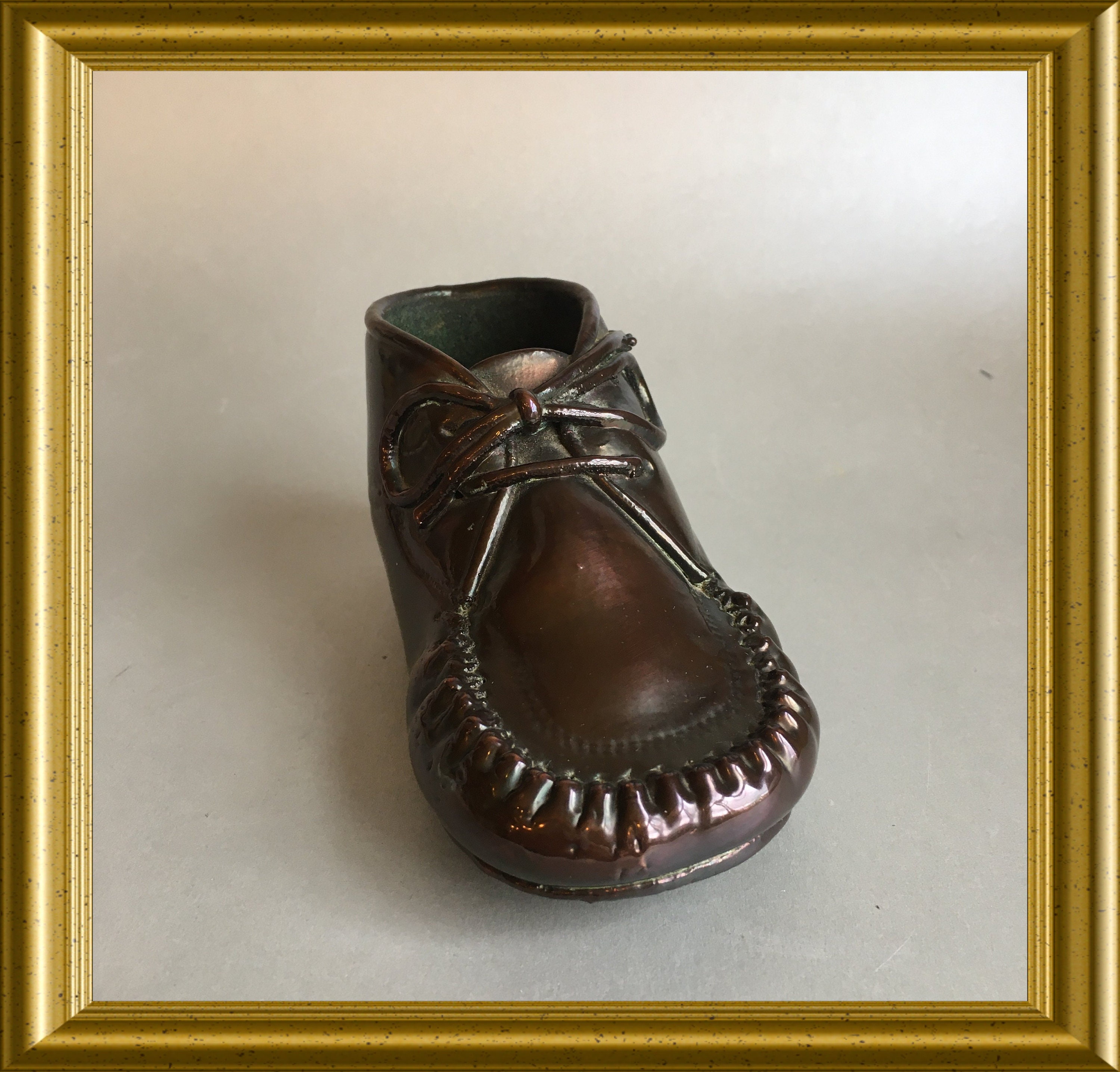 Vintage bronzed children's shoe