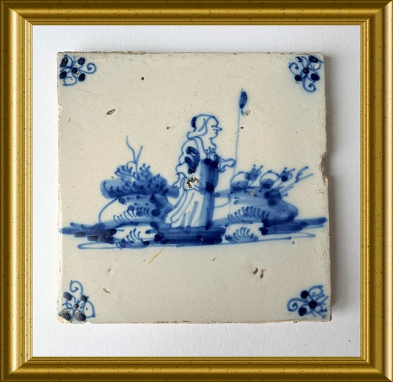 Antique glazed earthenware tile: female shepherd