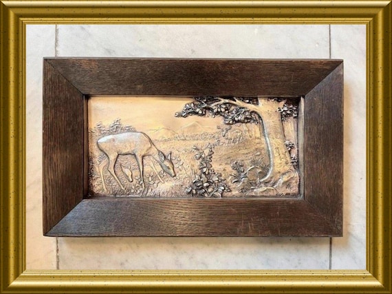Old metal plaque in wooden frame – Deer by a tree