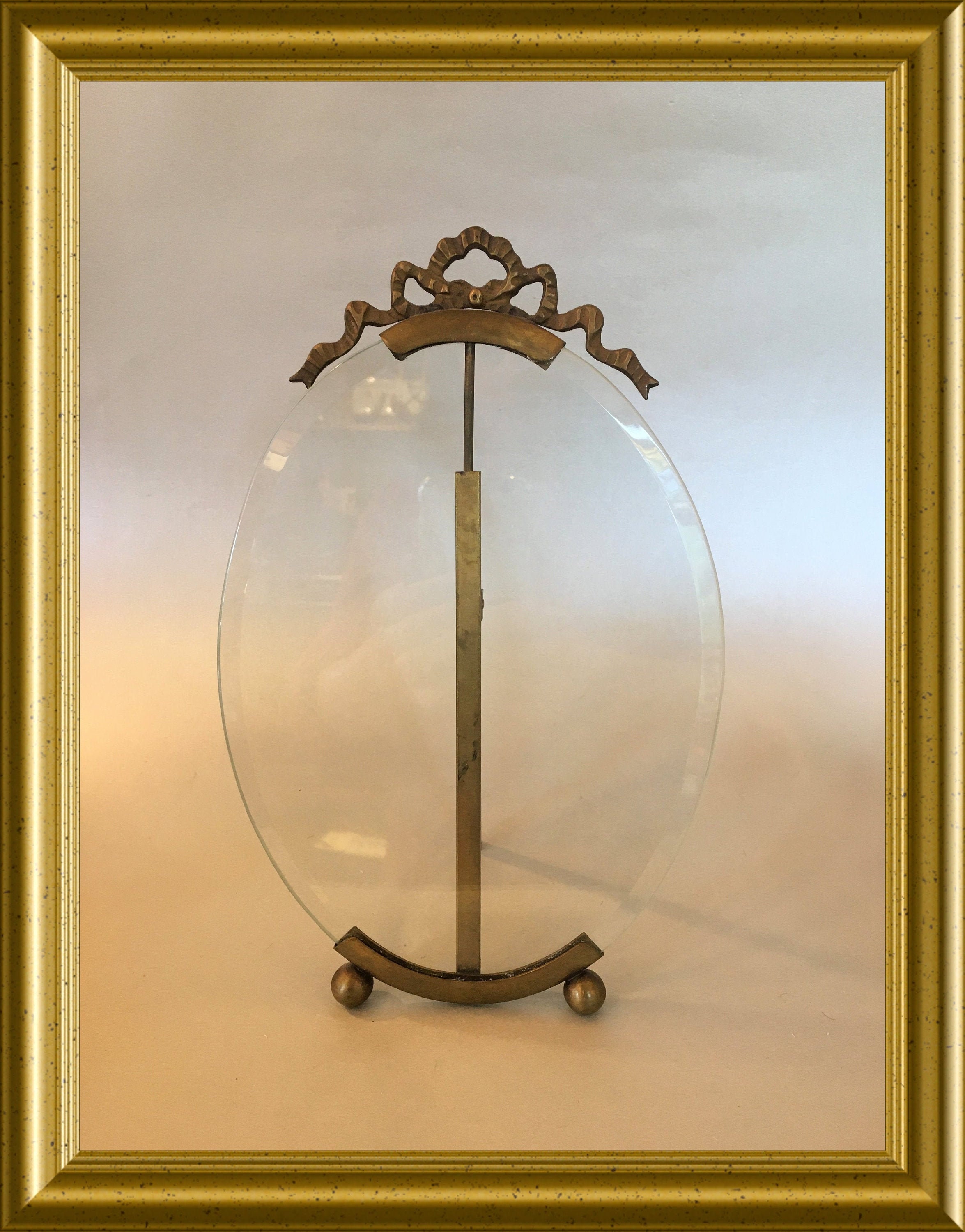 Antique large oval picture frame with beveled glass and bow