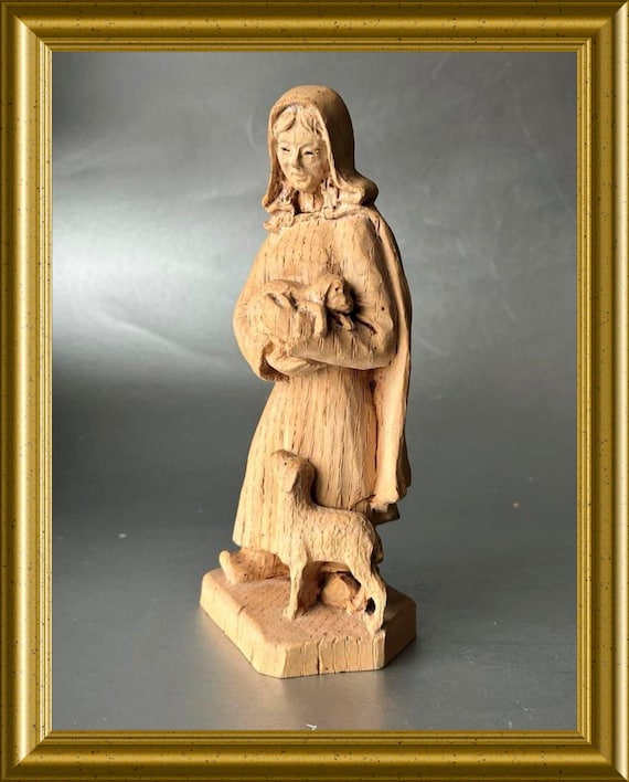 Vintage woodcarving: wooden shepherd figurine, woman with sheep, lambs