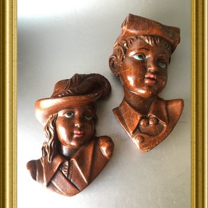 Two vintage Italian paper mache wall plaques: head boy and girl portrait wall masks