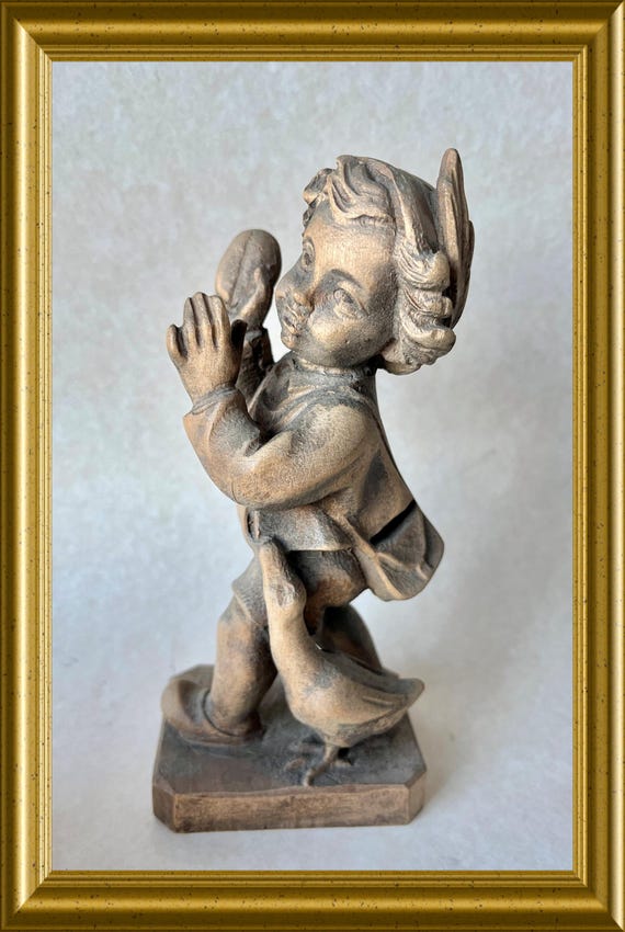 Vintage woodcarving: wooden figurine, boy with goose