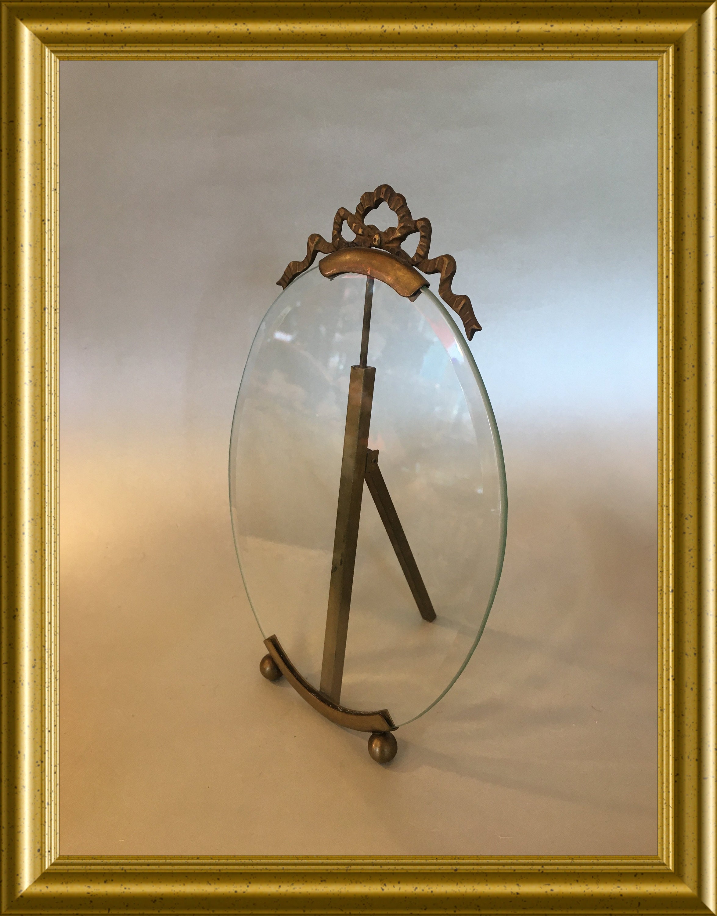 Antique large oval picture frame with beveled glass and bow