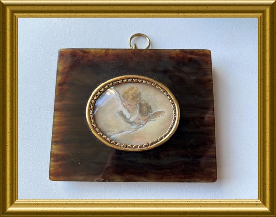 Vintage frame: miniature portrait painting, angels, putti