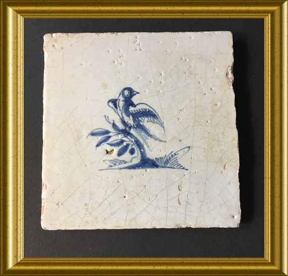 Antique glazed earthenware tile: bird