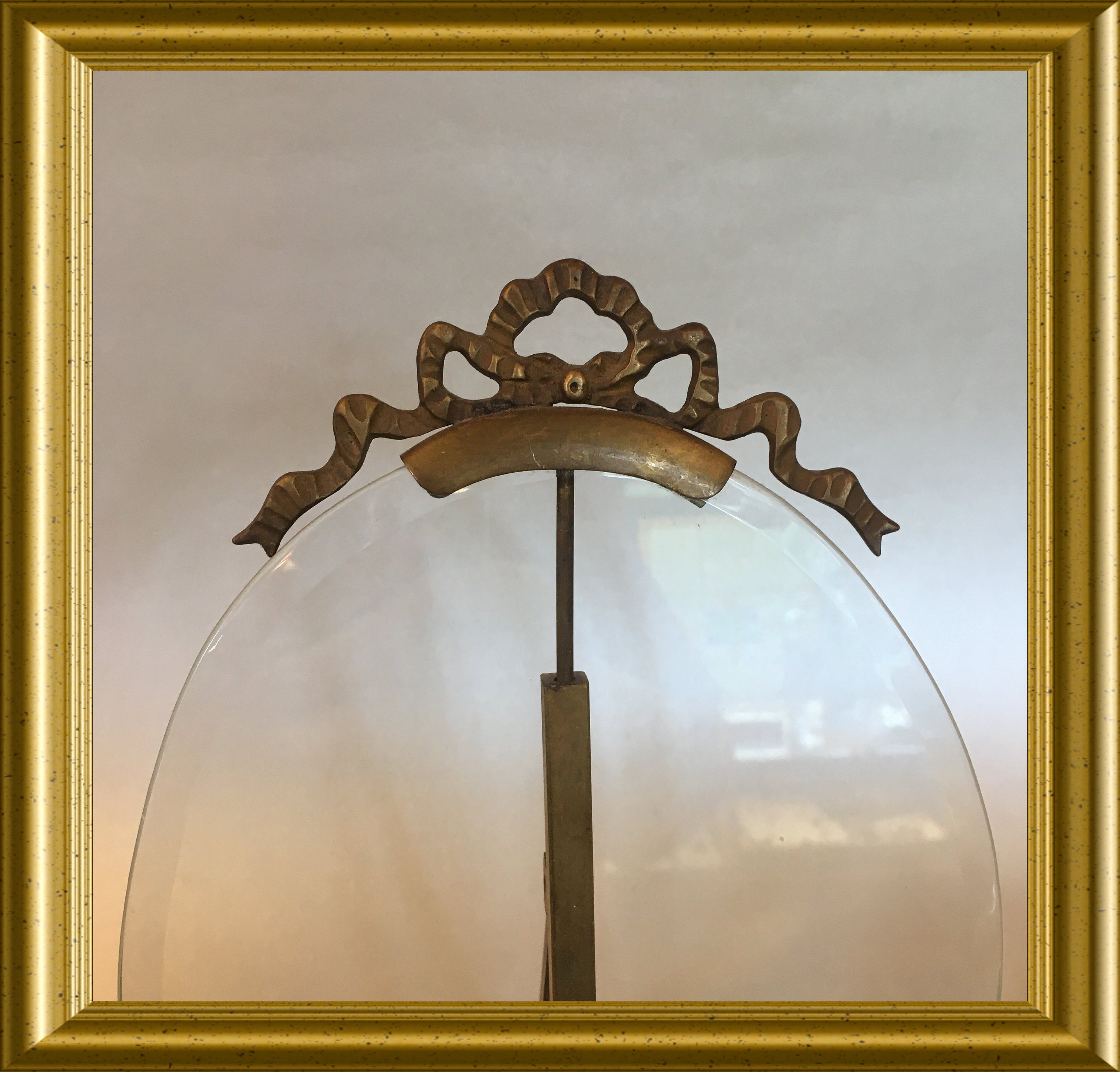 Antique large oval picture frame with beveled glass and bow