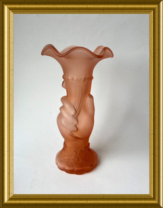 Pink frosted glass, hand holding vase