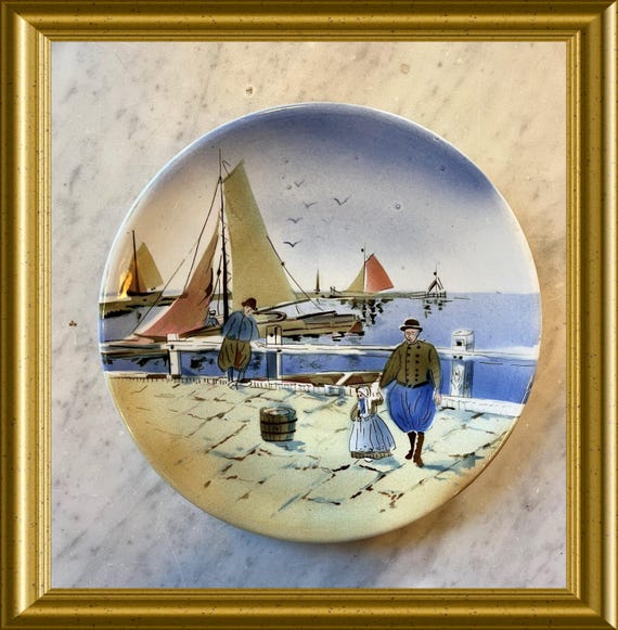 Old plate: traditional costume, sailboat