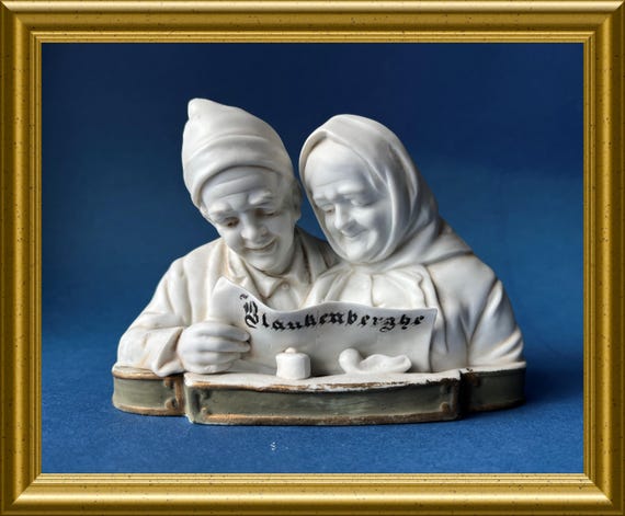 Antique white bisque porcelain figurine: elderly reading newspaper Blankenberghe