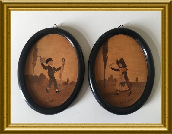 Two antique oval wooden frames/ wall hangings: inlaid wood, marquetry