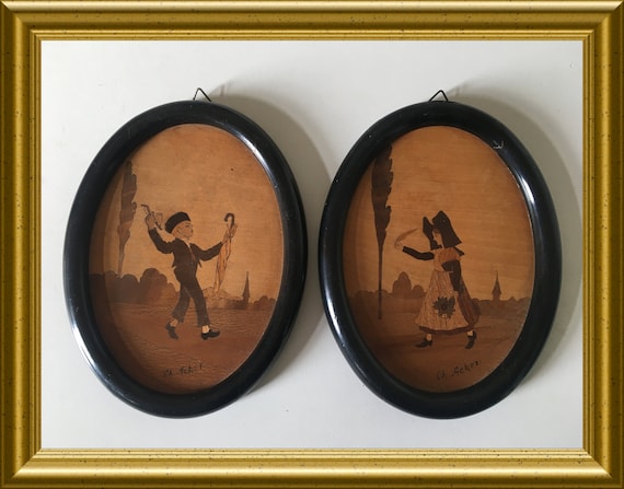 Two antique oval wooden frames/ wall hangings: inlaid wood, marquetry