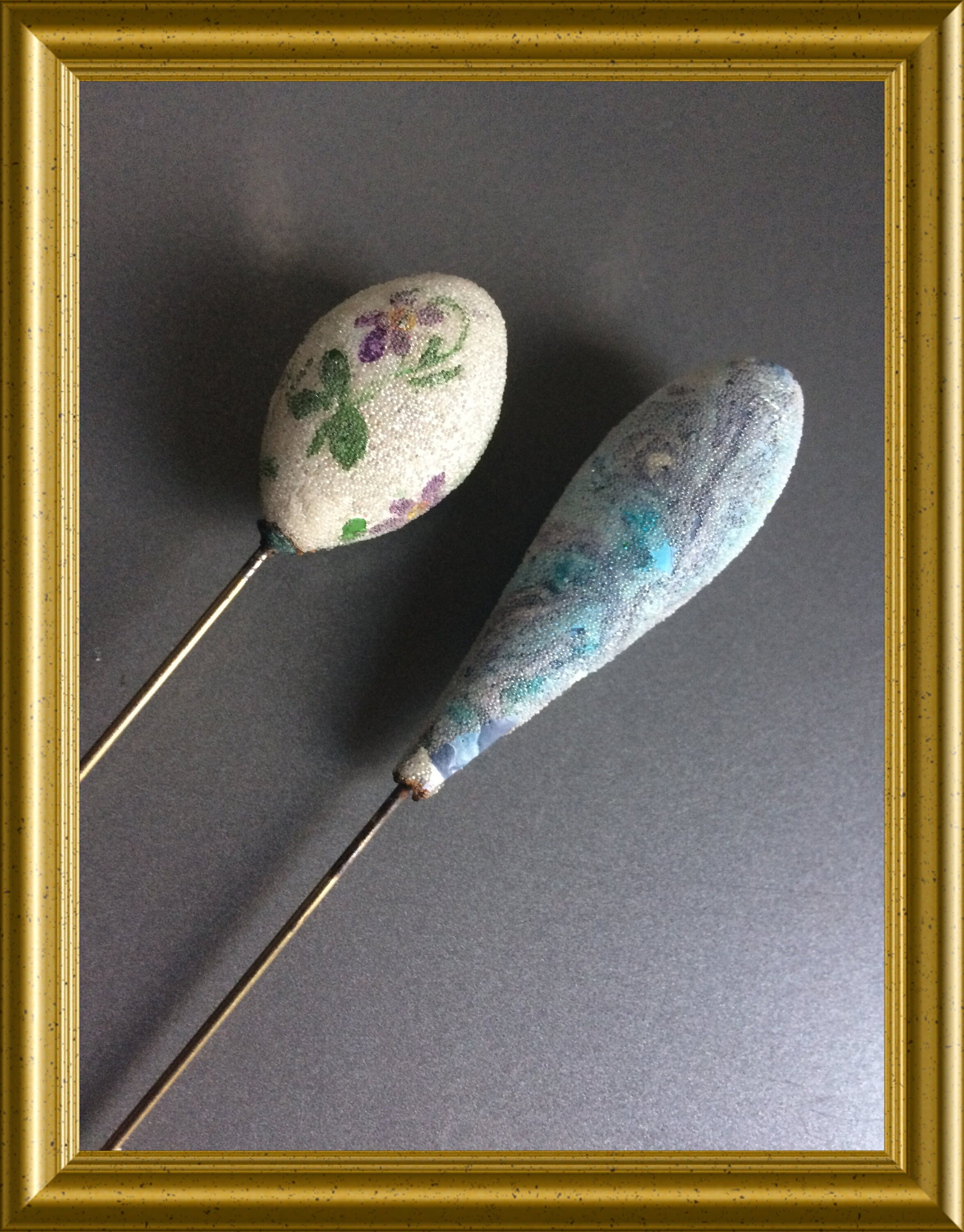 Two lovely long antique glass hat pins