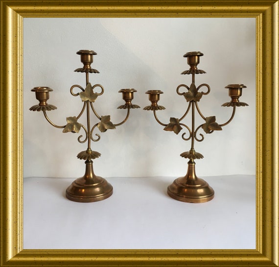 Two antique candle holders with leaves