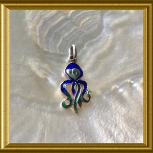 May include: A silver octopus pendant with blue and green enamel. The octopus has a detailed design with a heart-shaped head and eight tentacles.