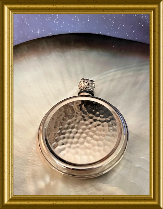 Vintage round metal perfume bottle