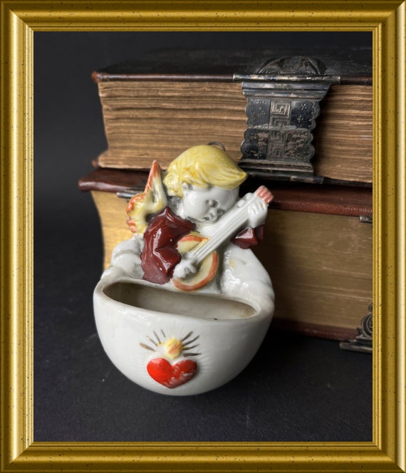 Antique porcelain holy water font: angel with lute