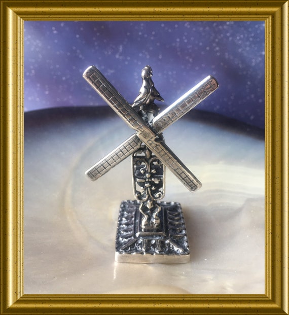 Miniature silver windmill with turning blades