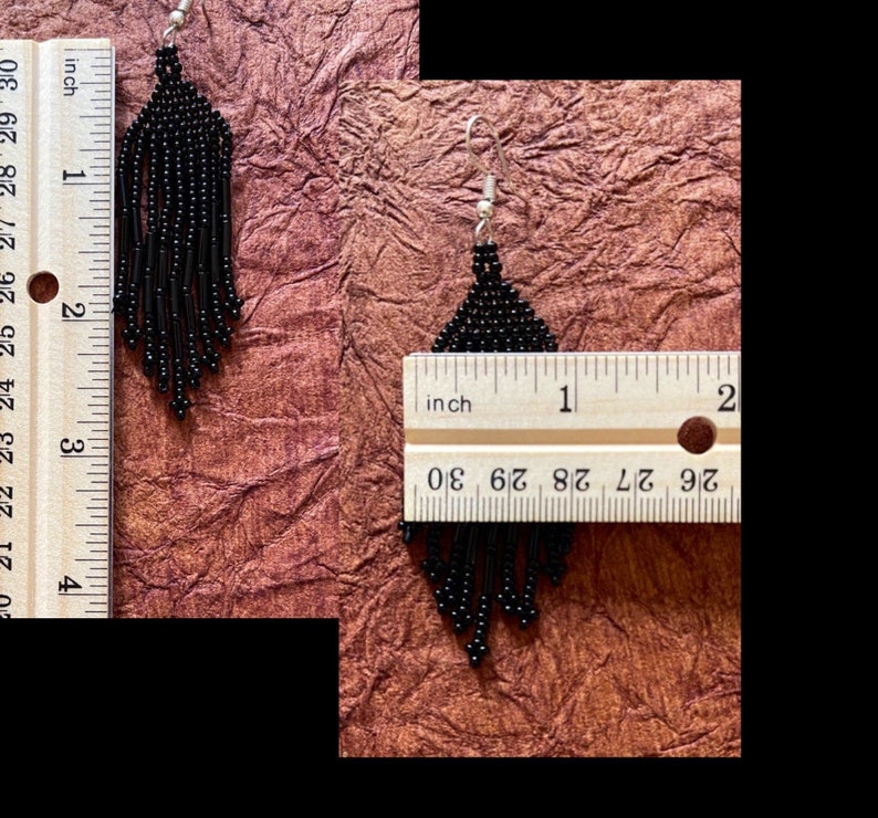 May include: Black beaded fringe earrings measuring approximately 2 inches in length. The earrings are shown next to a ruler for size reference.