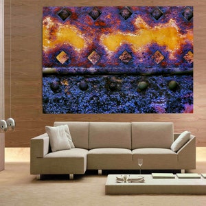 Peut inclure: Impression d'art abstrait repr&eacute;sentant une surface m&eacute;tallique rouill&eacute;e aux couleurs pourpre et jaune. Le m&eacute;tal a une surface textur&eacute;e avec des trous en forme de diamant et un aspect d&eacute;lav&eacute; et us&eacute;.