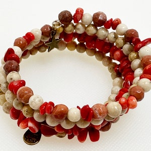 May include: Multi-strand bracelet made of red, white, and brown beads. The bracelet has a star charm.