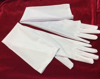 May include: A pair of white long fingerless gloves. The gloves are made of a silky material and have a smooth finish.