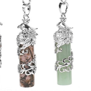 May include: Four silver pendant necklaces with different colored stones. Each pendant features a silver bird design with intricate details. The stones are a light brown, pink and brown, light green, and blue.