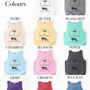May include: A collection of eleven sleeveless tank tops in white, grey, ivory, butter, island reef, chambray, blossom, pepper, grape, crimson, and blue jean. Each features a black graphic of a shoe and umbrella with the text My Darling Girl.