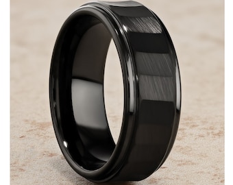 May include: A black tungsten carbide ring with a brushed finish and a beveled edge.
