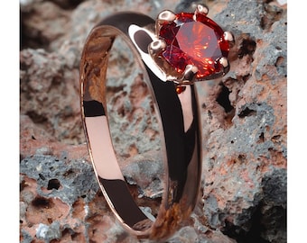 Robijn solitaire titaniumring, trouwring, verloving en jubileum, roségouden trouwring, enkele edelsteenring, trouwring dames