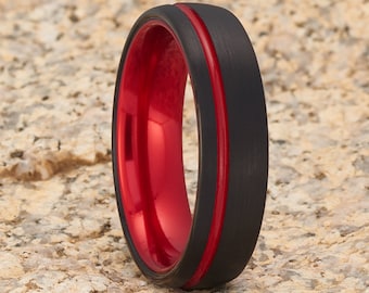 May include: A black tungsten carbide ring with a red inner band and a brushed finish.
