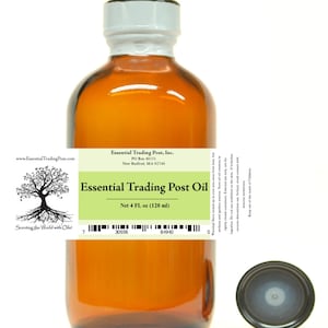May include: A brown glass bottle of Essential Trading Post Oil with a white cap and a black lid. The label states "Essential Trading Post Oil" and "Net 120 ml". The bottle is on a white background.
