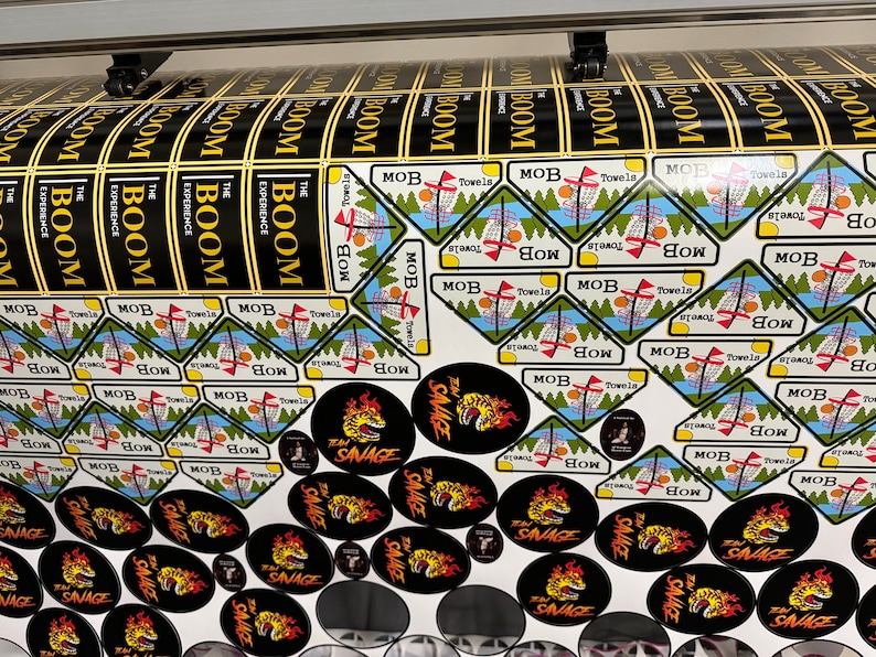 A table setup with stickers used for an event, showcasing how they are perfect for promotions.